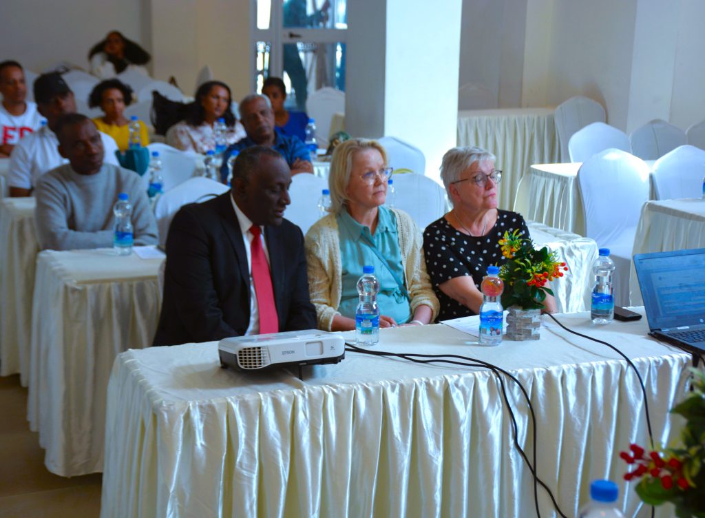 Panel speakers and audience at a project-launch workshop.
