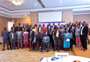 Partners and participants gather for the Inclusive Education for All project launch. Two participants in the front row use wheelchairs.